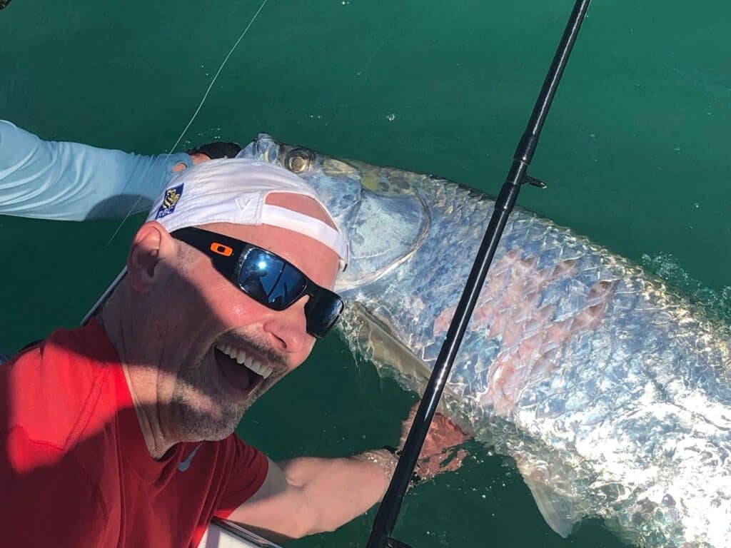 Angler poses beside a Boca Grande area tarpon
