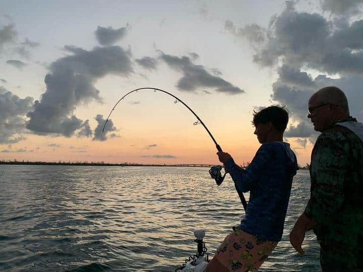 Angler fights a fish in evening light in the Boca Grande area