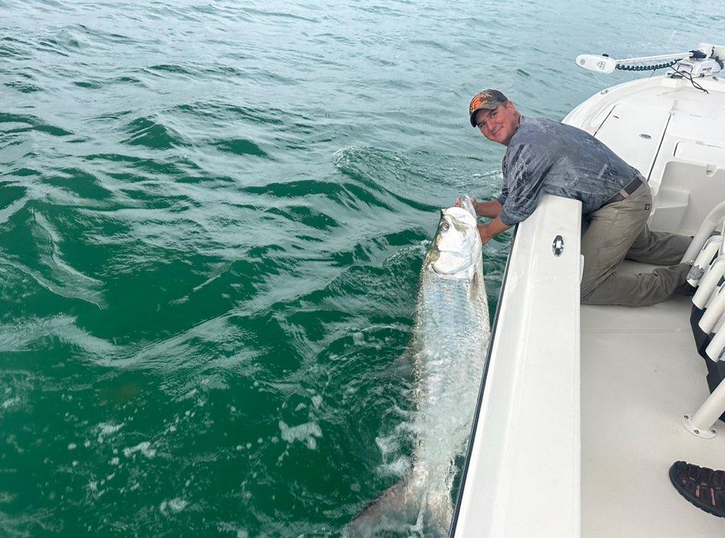 Large tarpon beside a boat in the Boca Grande area